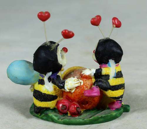 Miniature little bees having fun with a lemon