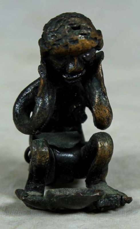 Miniature metal thinking man