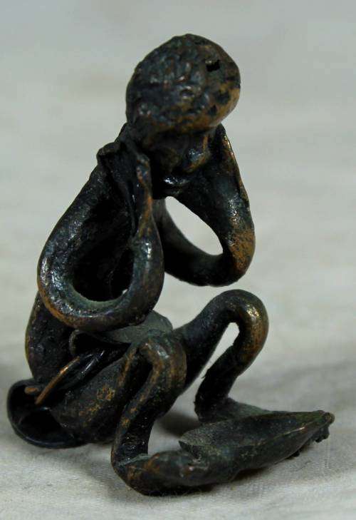 Miniature metal thinking man