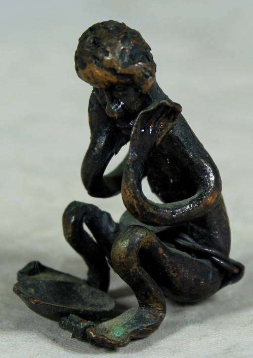 Miniature metal thinking man