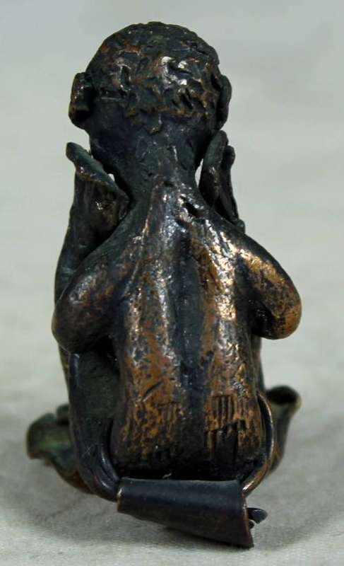 Miniature metal thinking man