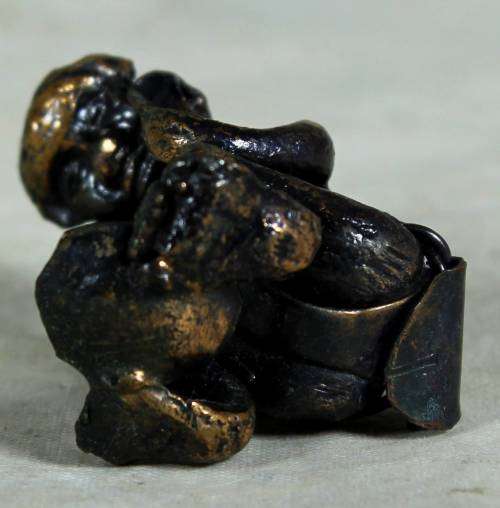 Miniature metal thinking man
