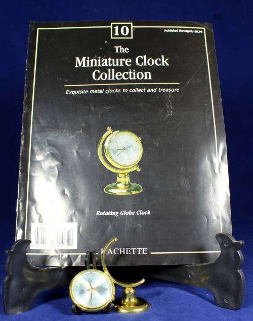 EXQUISITE HACHETTE MINITURE CLOCK WITH BOOKLET-ROTATING GLOBE-BID NOW!