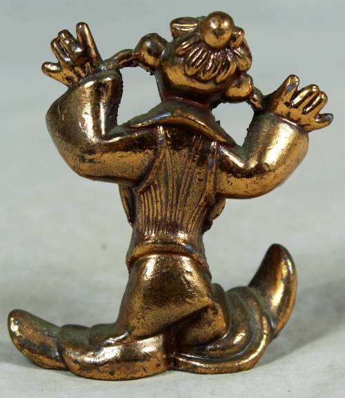 Miniature brass color lead clown with his fingers in his ears