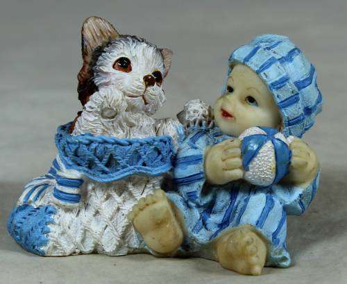 Baby with a cat in a basket