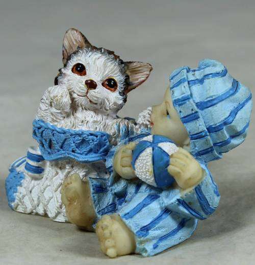 Baby with a cat in a basket