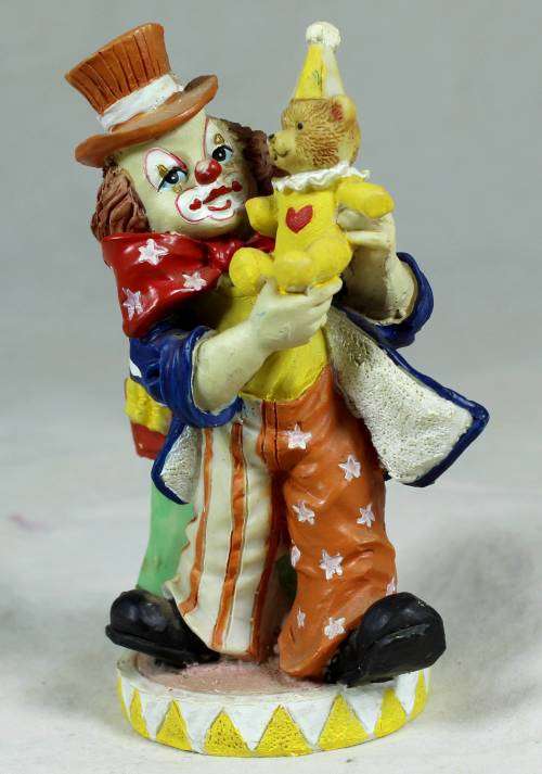 Small multi-colored clown with a bear