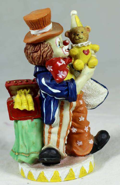 Small multi-colored clown with a bear