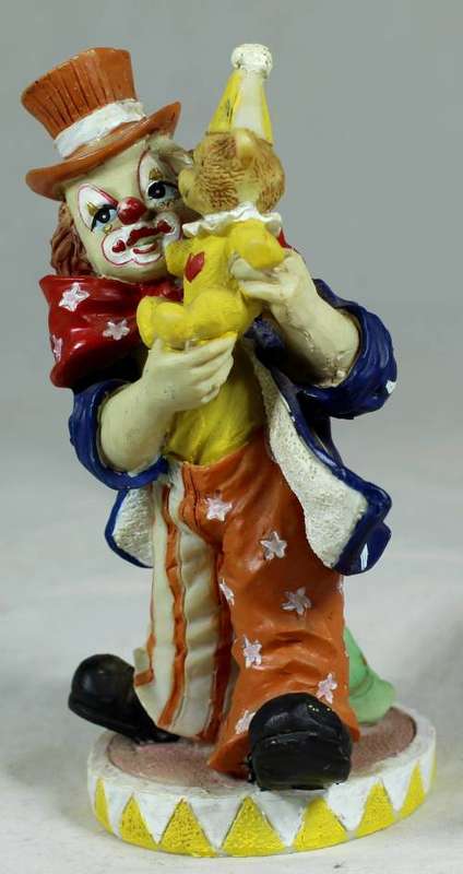 Small multi-colored clown with a bear