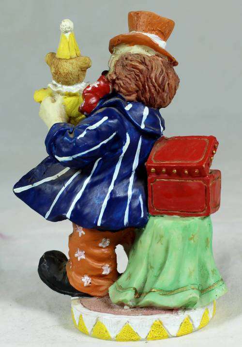 Small multi-colored clown with a bear
