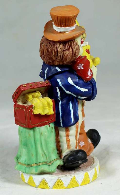 Small multi-colored clown with a bear
