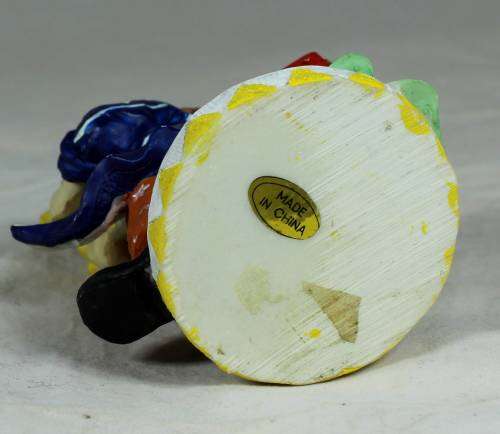 Small multi-colored clown with a bear