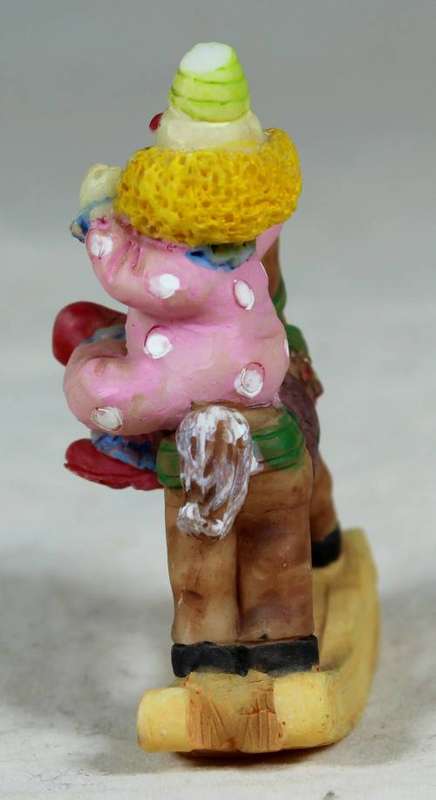 Miniature baby clown on a rocking horse