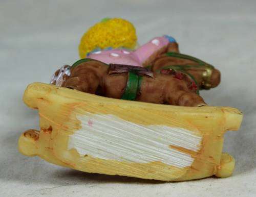 Miniature baby clown on a rocking horse