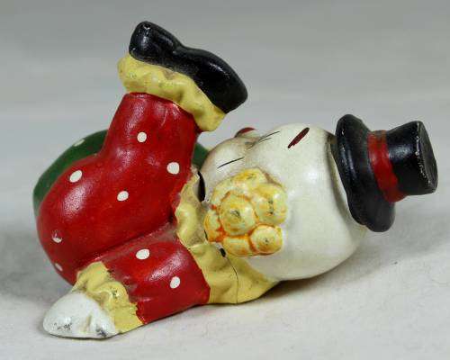 Miniature clown on his back with his foot in the air