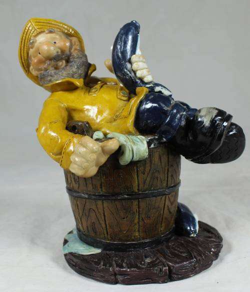 Sailor in a barrel holding a fish