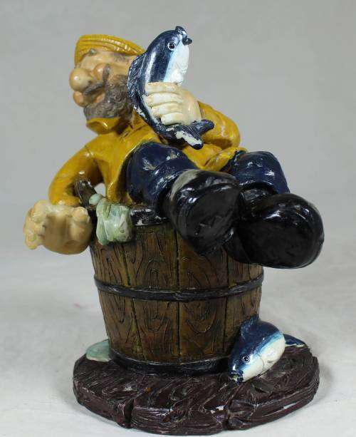 Sailor in a barrel holding a fish