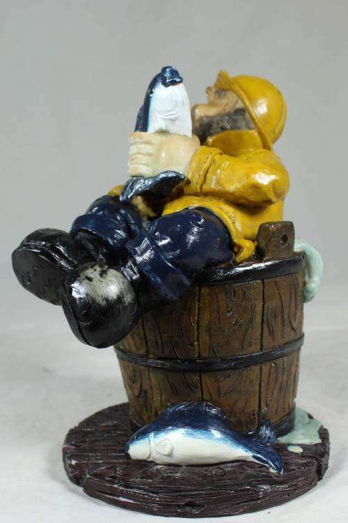 Sailor in a barrel holding a fish
