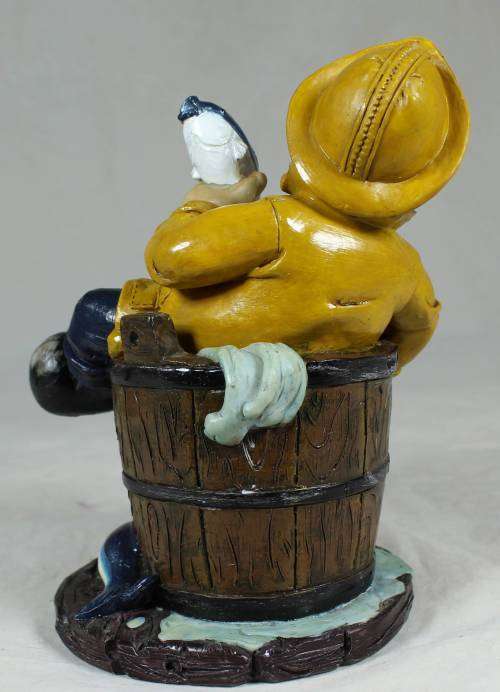 Sailor in a barrel holding a fish