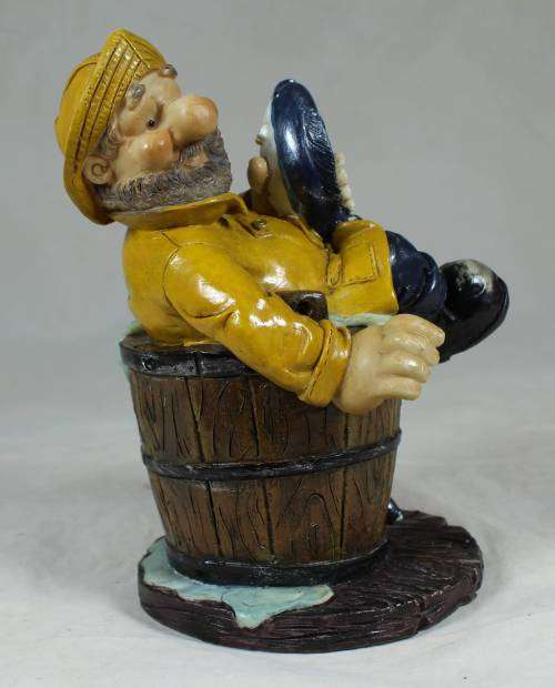 Sailor in a barrel holding a fish