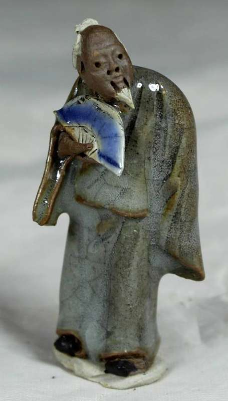 Collectible mud men - man holding a fan