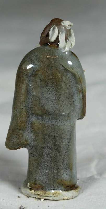 Collectible mud men - man holding a fan