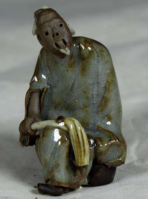Collectible mud men - man holding a whip
