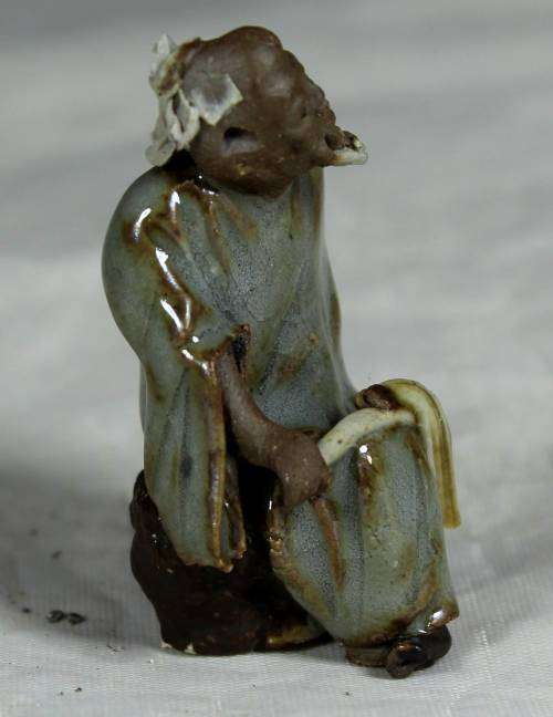 Collectible mud men - man holding a whip