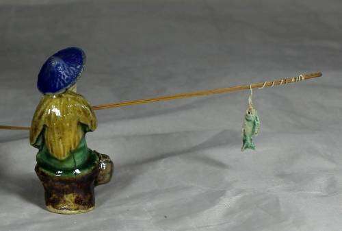 Mud Men - Old man seated & fishing in a blue hat