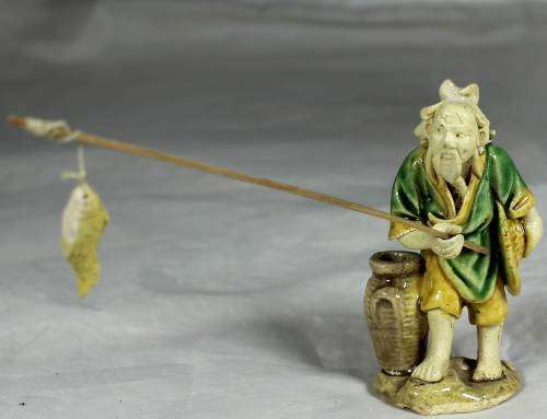 Mud Men - Old man holding a fish and hat