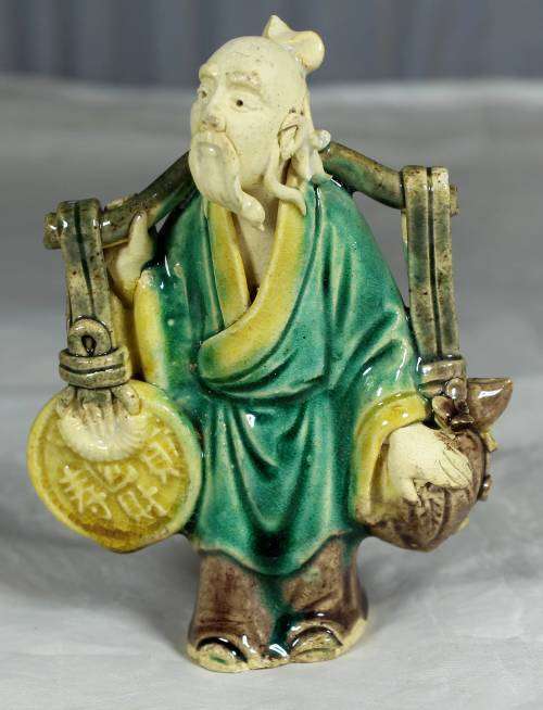 Collectible mud men - old man carrying a large disk