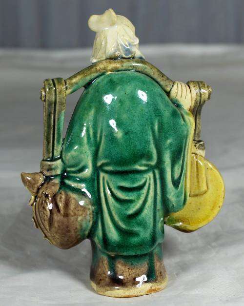 Collectible mud men - old man carrying a large disk
