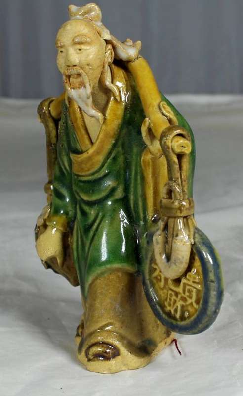 Collectible mud men - old man carrying a disk