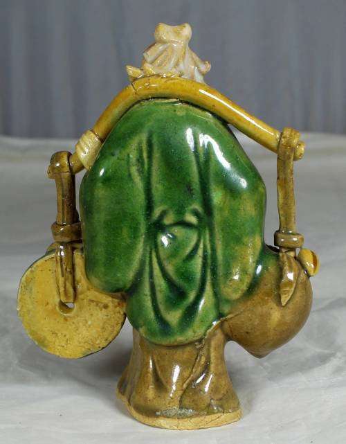 Collectible mud men - old man carrying a disk