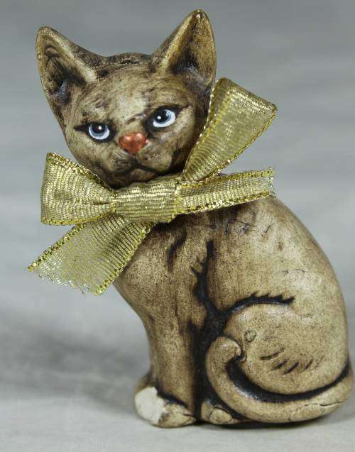 MINIATURE CAT SEATED WITH A BOW TIE(BEAUTIFUL) BID NOW !!