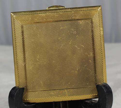 Powder compact with raised rhombus