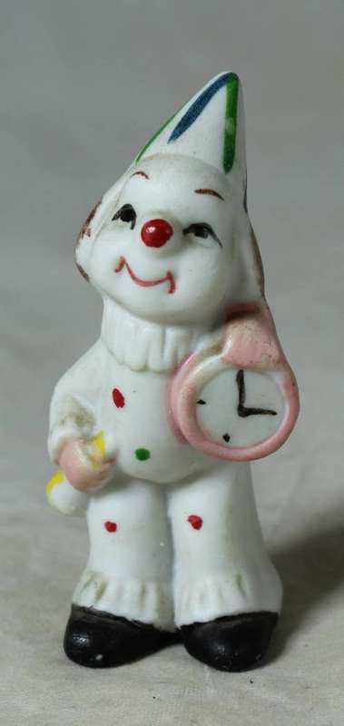 Miniature clown holding a large clock