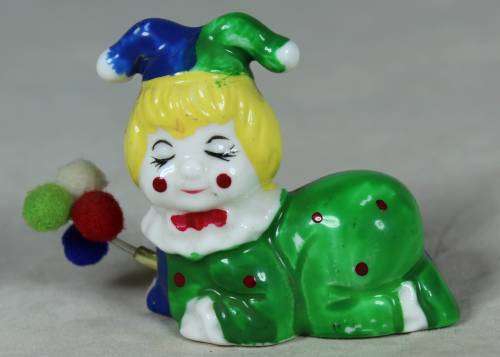 Miniature clown lying down with balloons