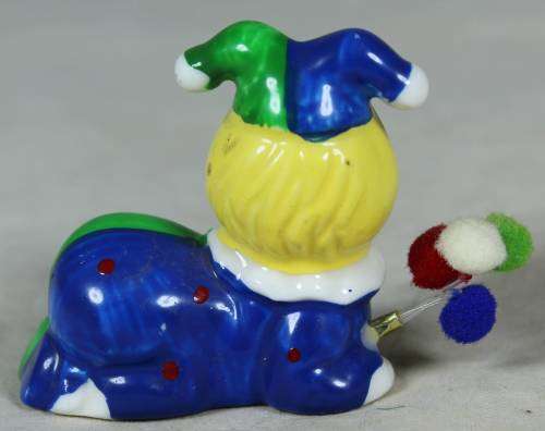 Miniature clown lying down with balloons