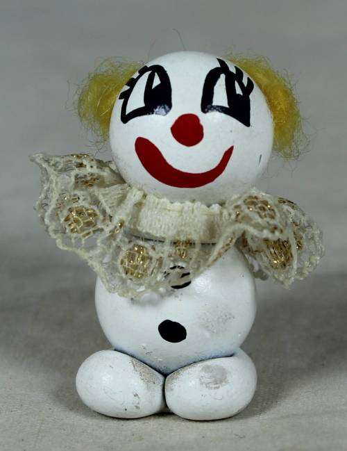 Miniature clown with a broad red smile