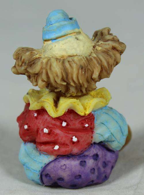 Miniature clown seated holding his shoe