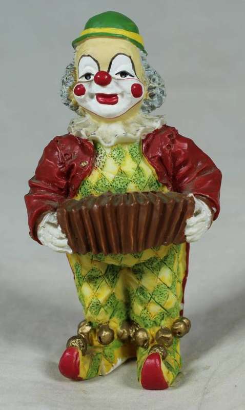 Miniature clown playing a concertina