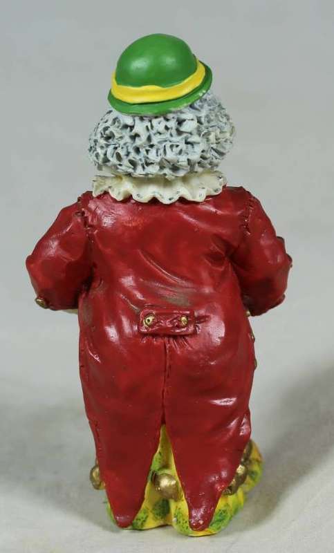 Miniature clown playing a concertina