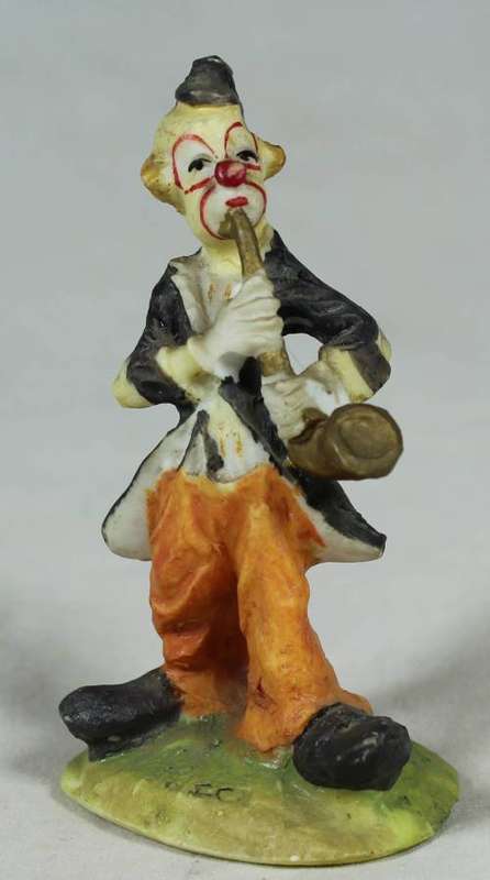 Miniature clown playing a saxophone