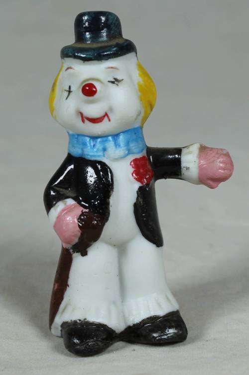Miniature clown holding a cane