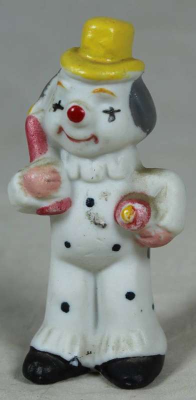 Miniature clown holding large baby bottle