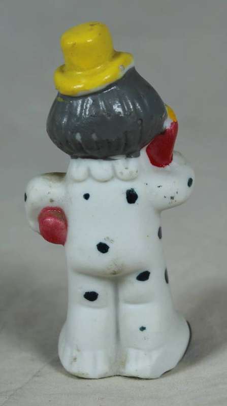 Miniature clown holding large baby bottle