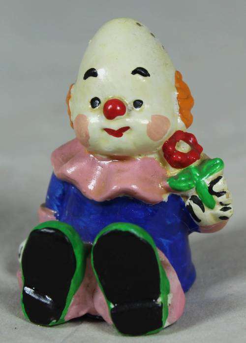 Miniature baby clown with a rattle