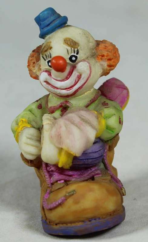 Miniature clown sitting in a shoe