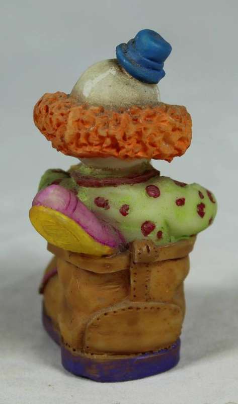 Miniature clown sitting in a shoe